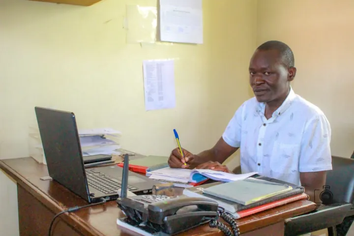 A MED25 clinician reviewing patient records at the hospital in Mbita